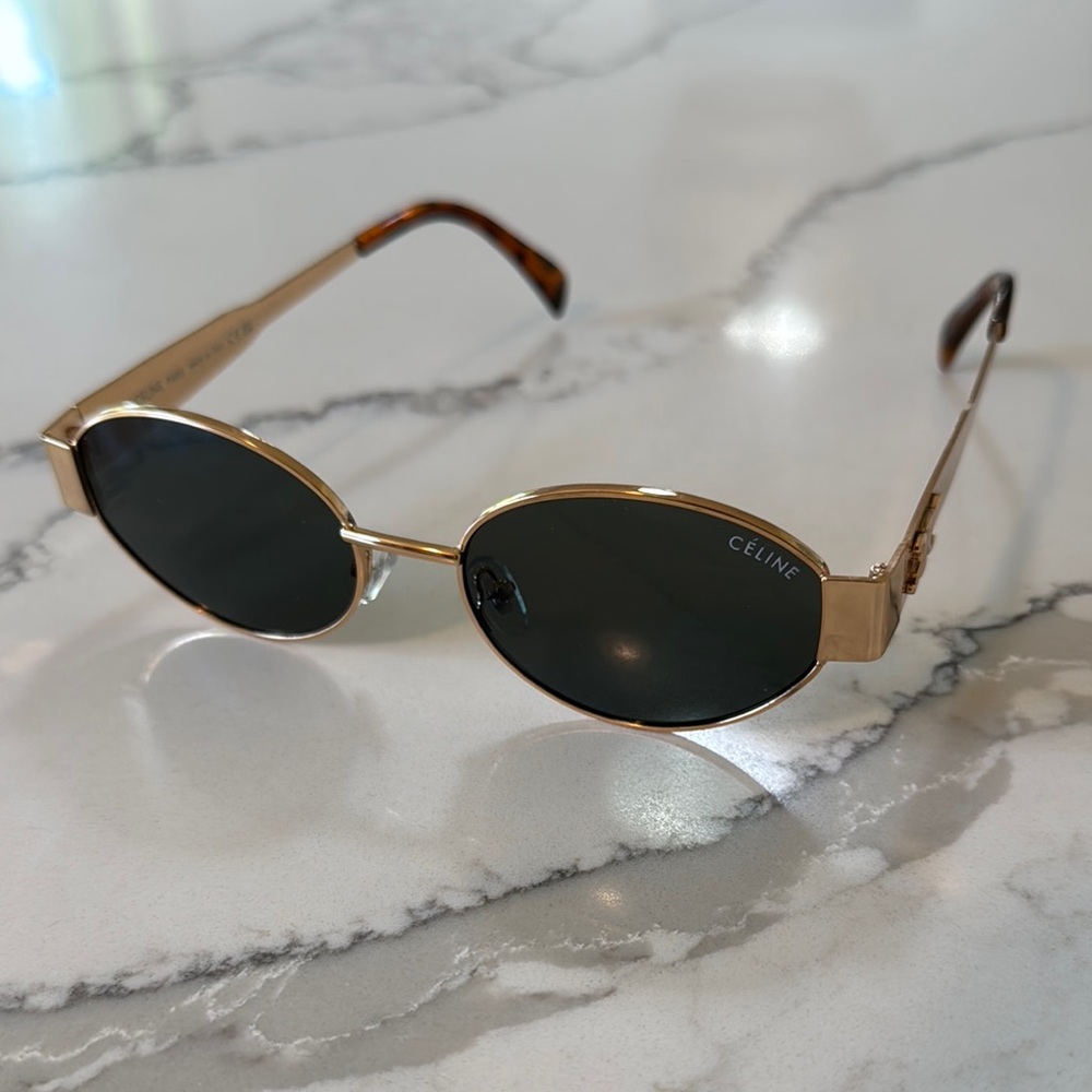 C e l  i n e. Sunglasses gold with dark lens.